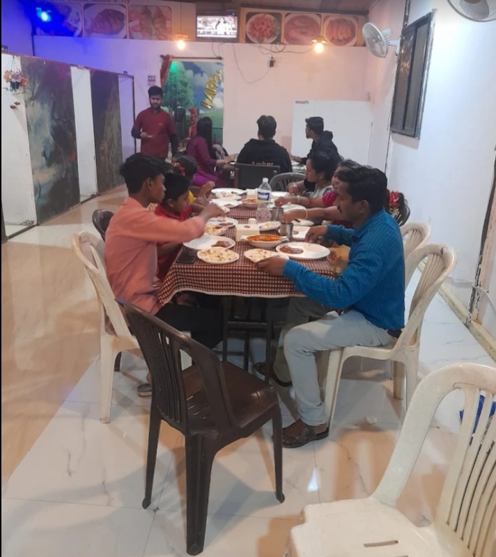 Guests sharing a meal at Shivshambu Family Restaurant