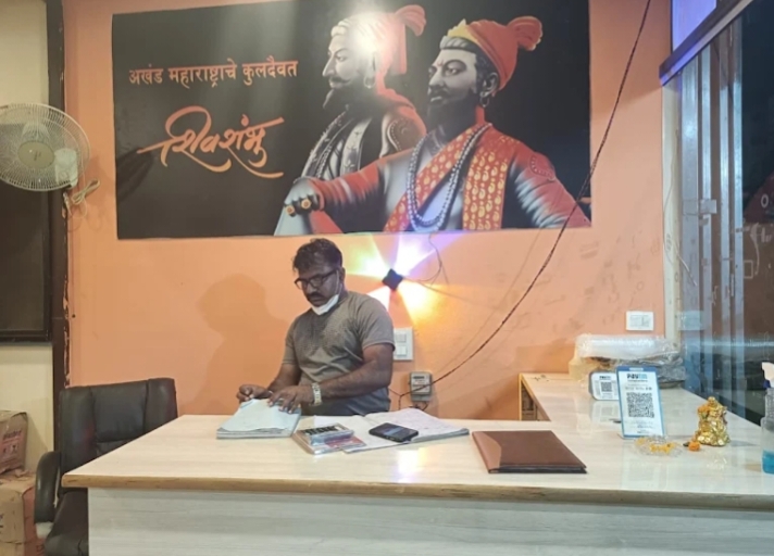 Restaurant reception desk beneath Chhatrapati Shivaji Maharaj artwork